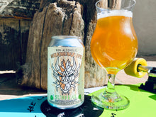 Load image into Gallery viewer, Can of Surreal Non-Alcoholic Milkshake IPA on a skateboard with a glass of orange gold beer poured out into a stemmed glass. Cream foam head. 
