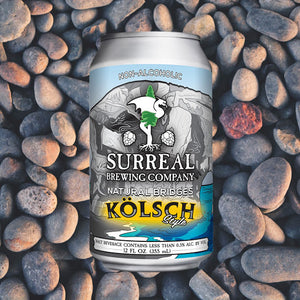 Can of Surreal Non-Alcoholic Kolsch Style. 17 Calories, Zero Sugar, 2.8 calories. Background stones.