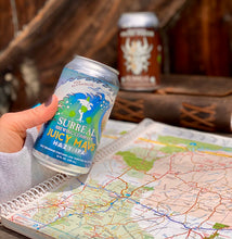Load image into Gallery viewer, Can of Surreal Non-Alcoholic Juicy Mavs Hazy IPA. 25 calories, zero sugar. Background map and can of Surreal NA Pastry Porter.
